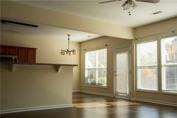 a view of wooden floor and windows in a room