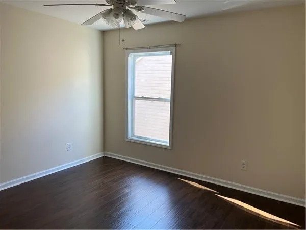 a view of an empty room and wooden floor