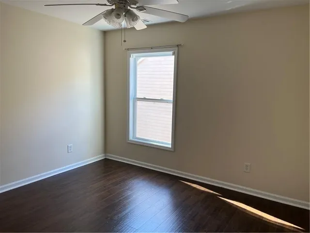 a view of an empty room and wooden floor