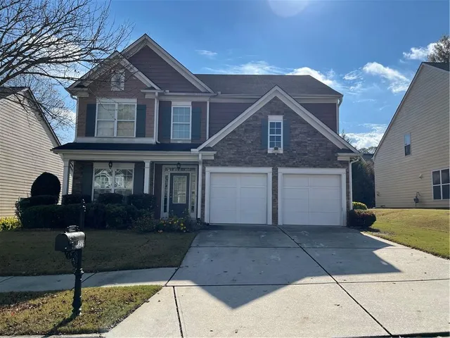 a front view of a house with garden