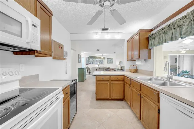 a kitchen with stainless steel appliances granite countertop a sink dishwasher stove and refrigerator