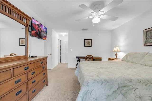 a bedroom with a large bed and a chandelier
