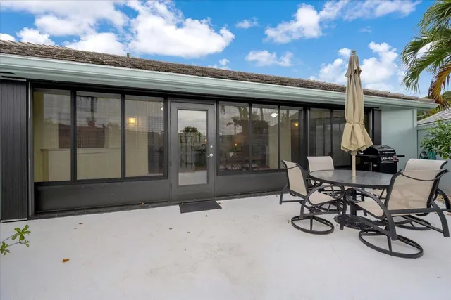 a view of a patio with table and chairs and potted plants