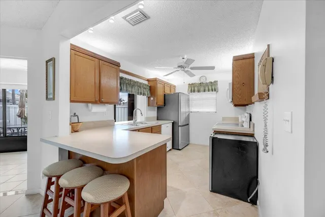 a kitchen with a sink cabinets and wooden floor