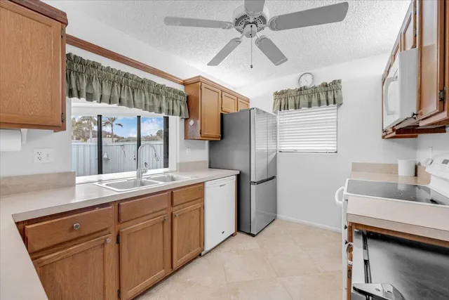 a kitchen with a sink and a refrigerator