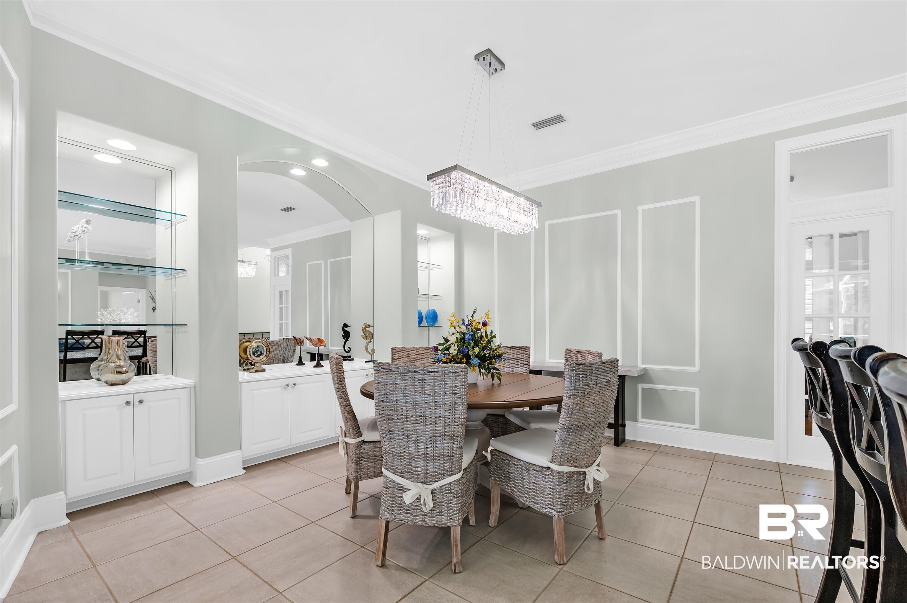 8160 Bay View Drive Foley, AL 36535 - Photo 14 of 43 Dining space featuring crown molding, light tile patterned floors, arched walkways, a chandelier, and recessed lighting