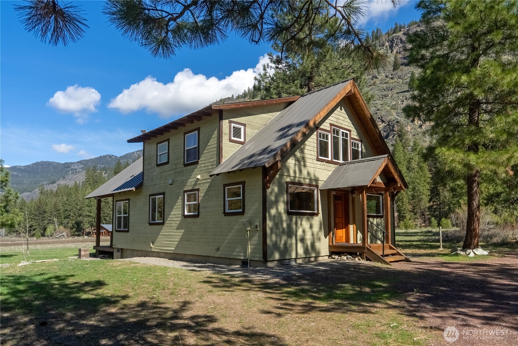 7 Last Chance Road Mazama, WA 98833 - Photo 14 of 40 a front view of a house with a yard