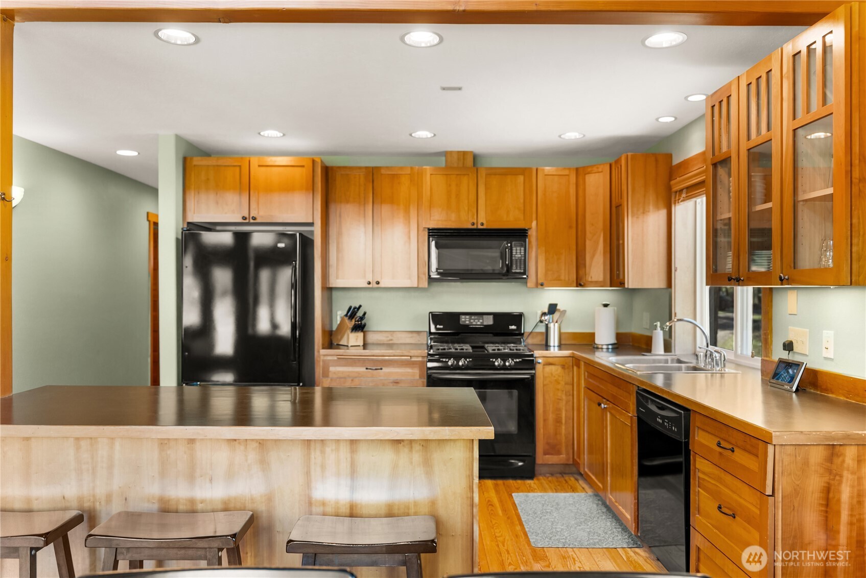 7 Last Chance Road Mazama, WA 98833 - Photo 18 of 40 a kitchen with a sink a counter top space cabinets and stainless steel appliances