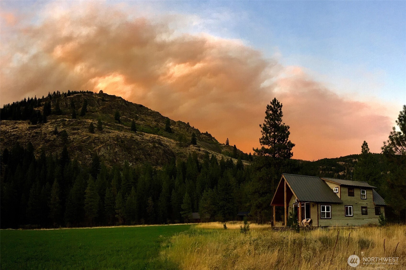 7 Last Chance Road Mazama, WA 98833 - Photo 31 of 40 a view of house with garden space and wooden bridge