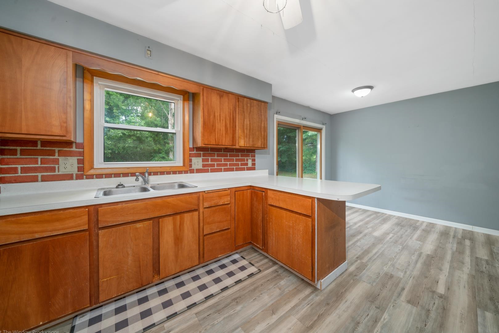 510 Elizabeth Road Oregon, IL 61061 - Photo 4 of 25 a kitchen with stainless steel appliances granite countertop wooden cabinets a sink and a large window