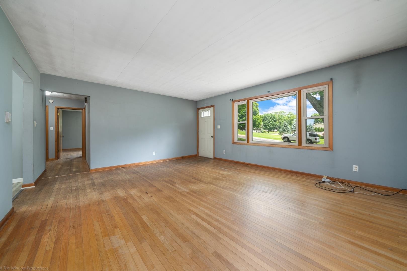 510 Elizabeth Road Oregon, IL 61061 - Photo 7 of 25 a view of an empty room with wooden floor and a window