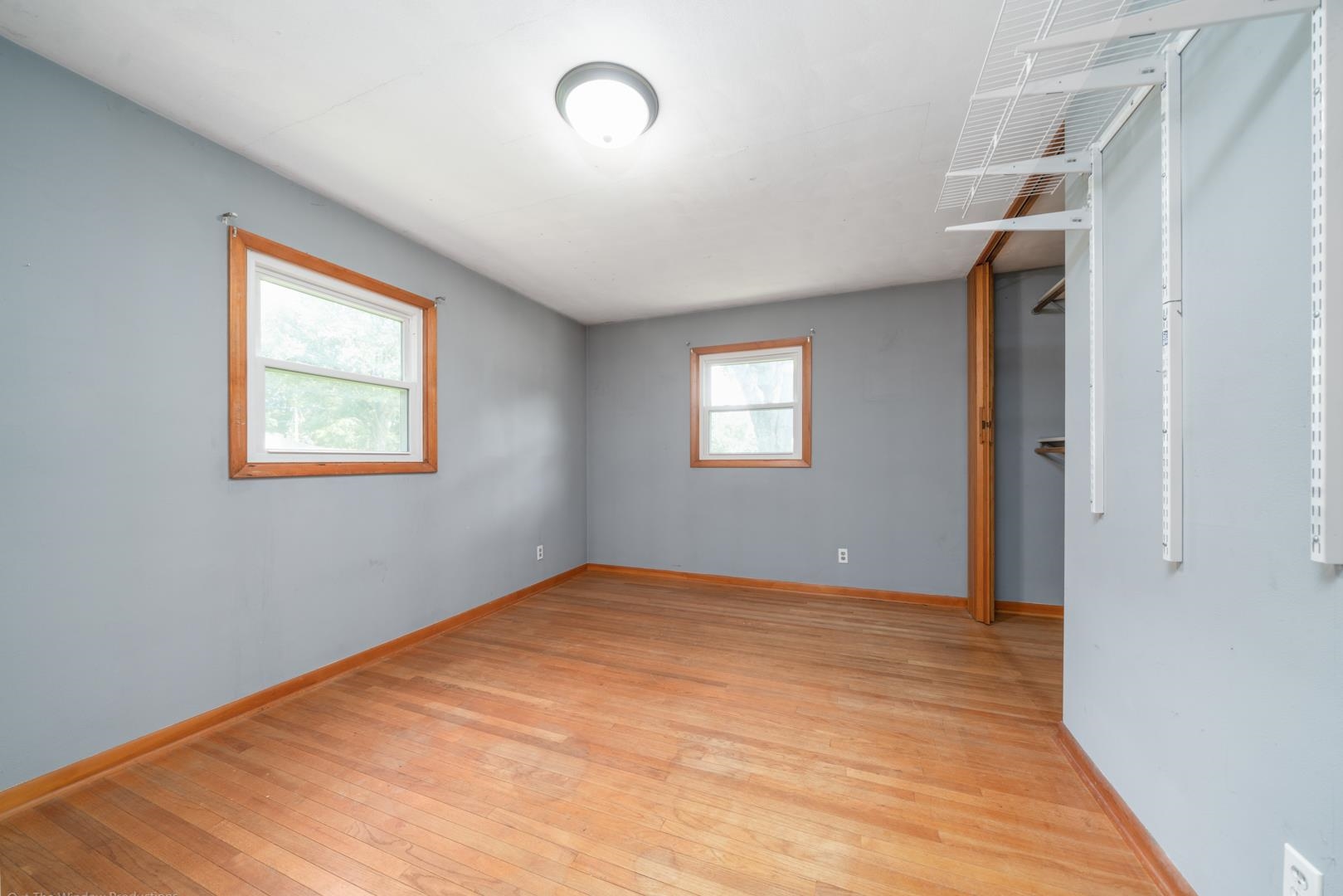 510 Elizabeth Road Oregon, IL 61061 - Photo 10 of 25 a view of an empty room with wooden floor and a window