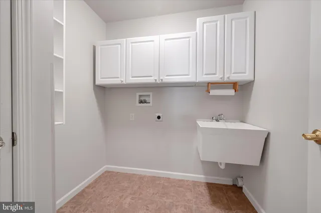 a room with a sink and cabinets
