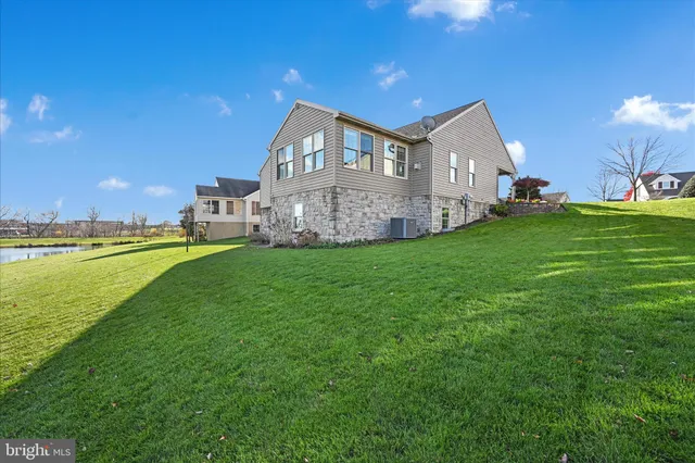 a view of a house with a yard and sitting area