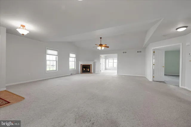 a view of empty room with a fireplace
