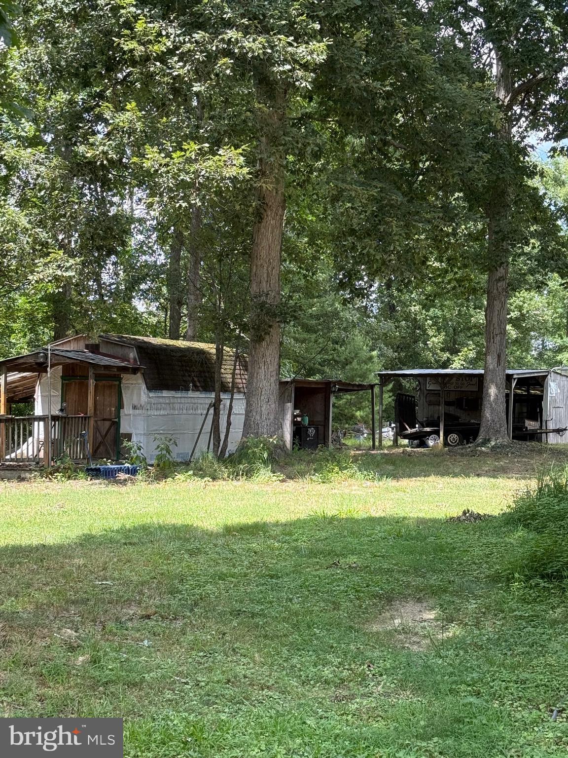 1915 Bumpass Road Bumpass, VA 23024 - Photo 3 of 17 a view of a backyard with table and chairs potted plants and large tree