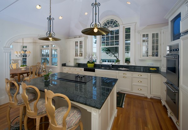 37 Bradlee Road Marblehead, MA 01945 - Photo 6 of 24 a kitchen with stainless steel appliances granite countertop a stove a sink dishwasher a dining table and chairs with wooden floor