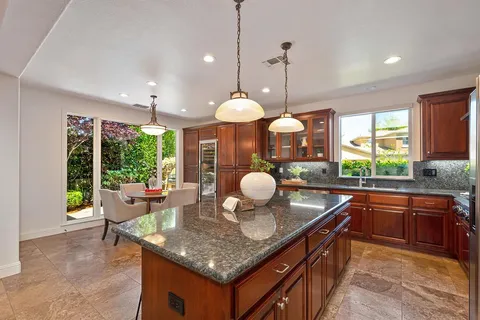 a dining room with furniture a chandelier and wooden floor