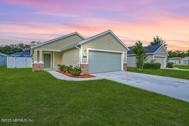 a view of a house with a yard and plants