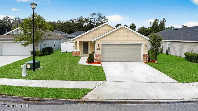 a view of a house with a patio and a yard