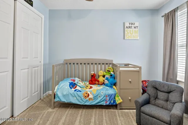 a bedroom with a bed dresser and a window