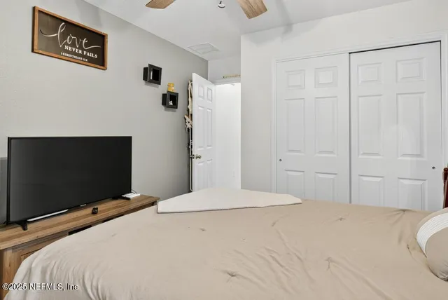a living room with furniture ceiling fan and a rug