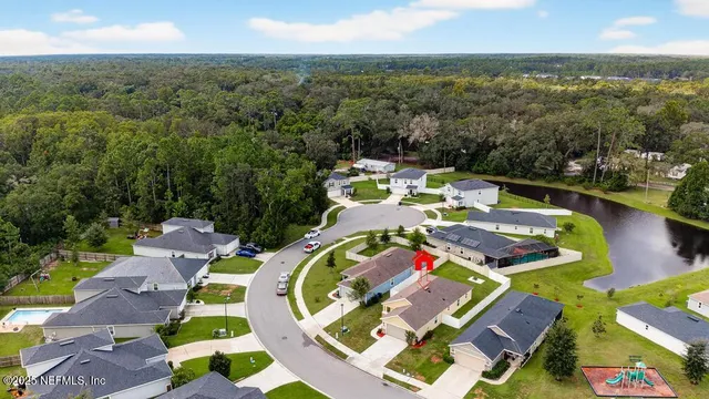 a view of a back yard with a table and chairs under an umbrella