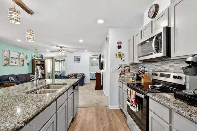 a view of kitchen island with granite countertop living room