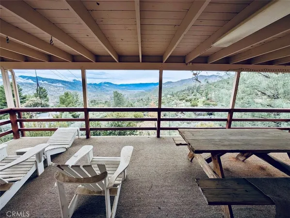 a view of a porch with furniture and wooden deck