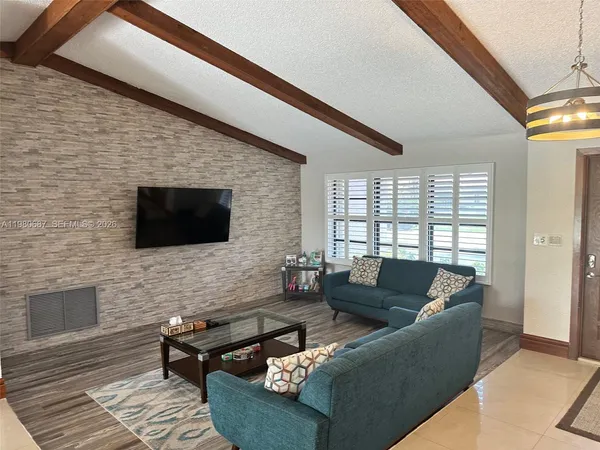 a lobby with furniture and floor to ceiling window