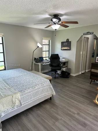 a view of a livingroom with workspace and a window