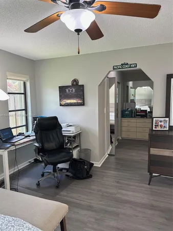 a bedroom with a bed a chandelier and a flat screen television