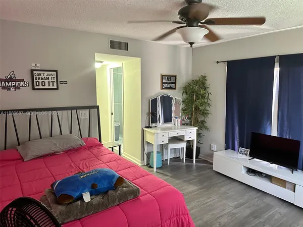 a bedroom with a bed and a chair