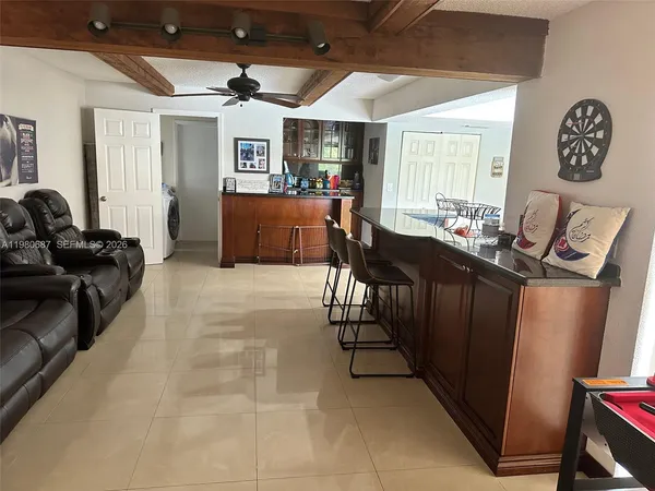 a view of a livingroom with furniture window and a wooden floor