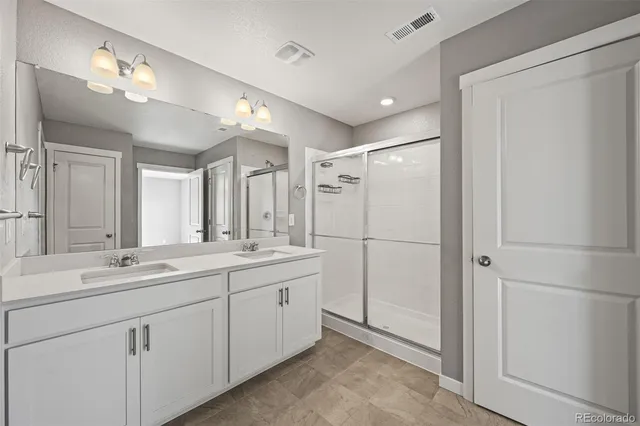 a bathroom with a double vanity sink mirror and double