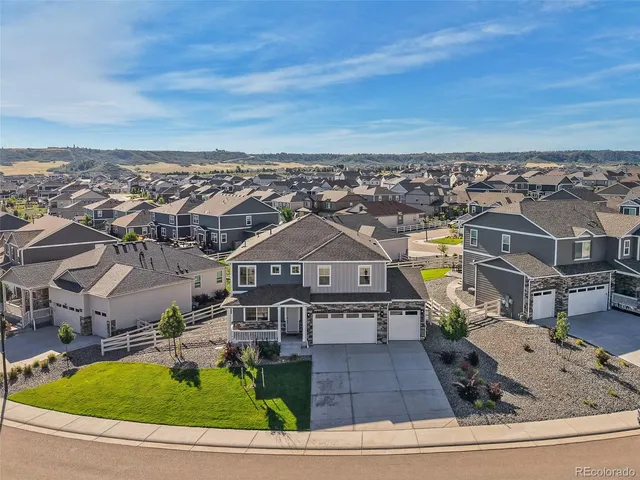an aerial view of residential houses with yard