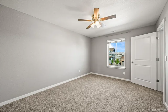 an empty room with window and stainless steel appliances
