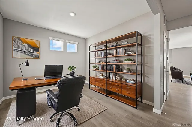 a view of a workspace with furniture and a window