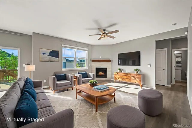 a living room with fireplace furniture and a flat screen tv