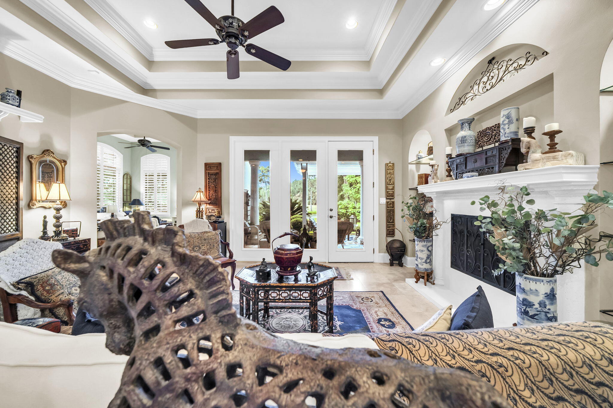 4470 Stonebridge Road Destin, FL 32541 - Photo 10 of 114 a living room with furniture a chandelier and a fireplace