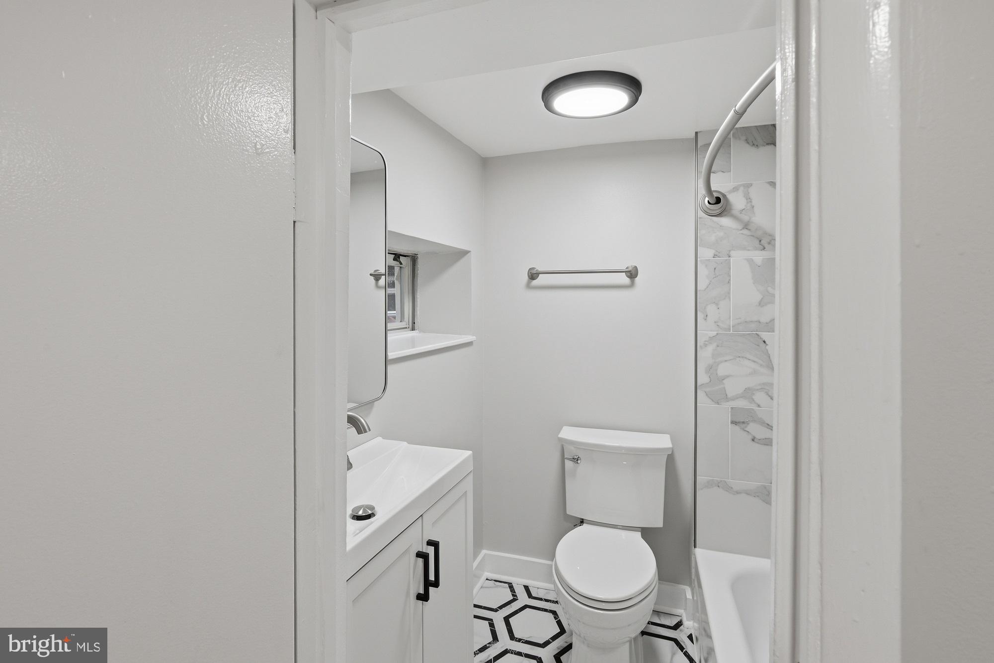 2388 Champlain Street Northwest, Unit 2 Washington, DC 20009 - Photo 11 of 13 a bathroom with a toilet a sink and a mirror