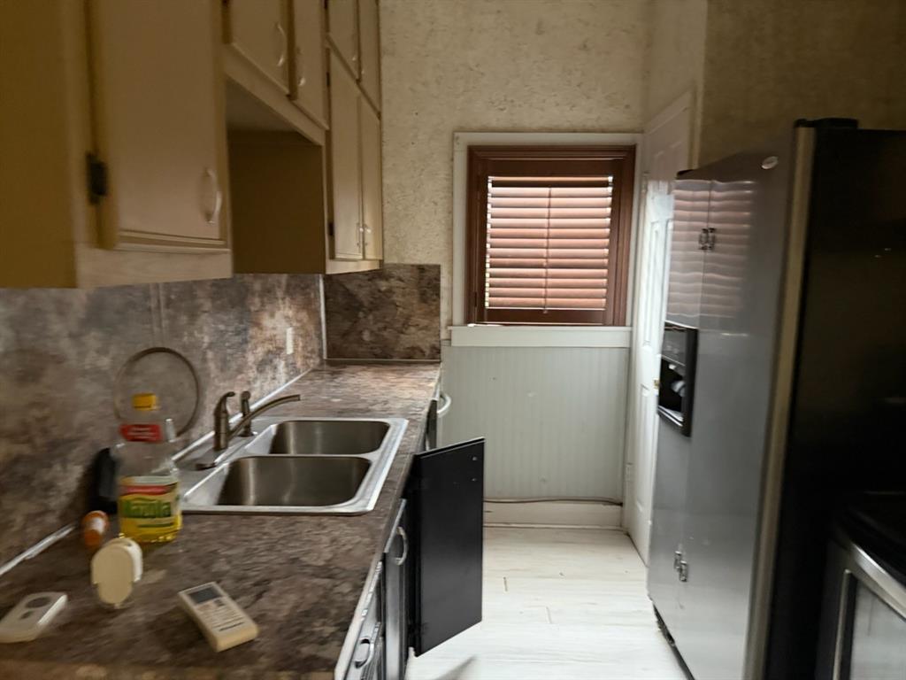 4050 Old Anson Road Abilene, TX 79601 - Photo 14 of 40 a kitchen with a sink and refrigerator