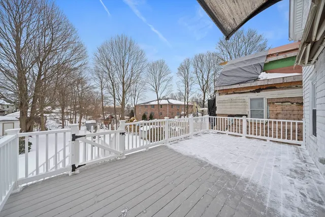a view of a house with a wooden fence