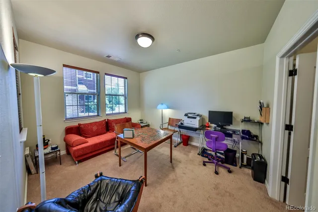 a bedroom with furniture and a large window