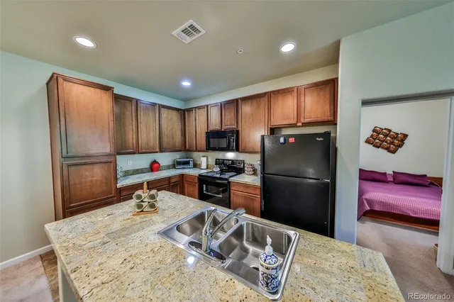 a kitchen with refrigerator and cabinets