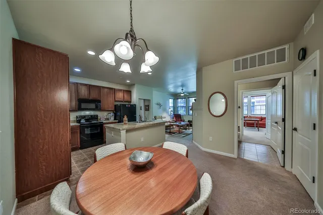 a large kitchen with a table and chairs