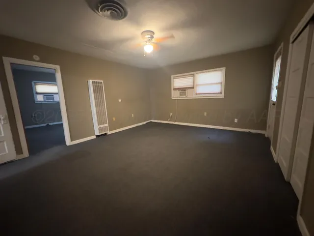 a view of an empty room and a window