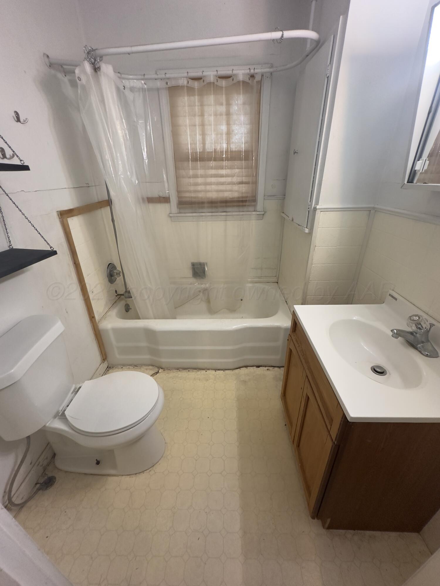 412 North 11th Street Memphis, TX 79245 - Photo 12 of 14 a bathroom with a sink toilet and shower