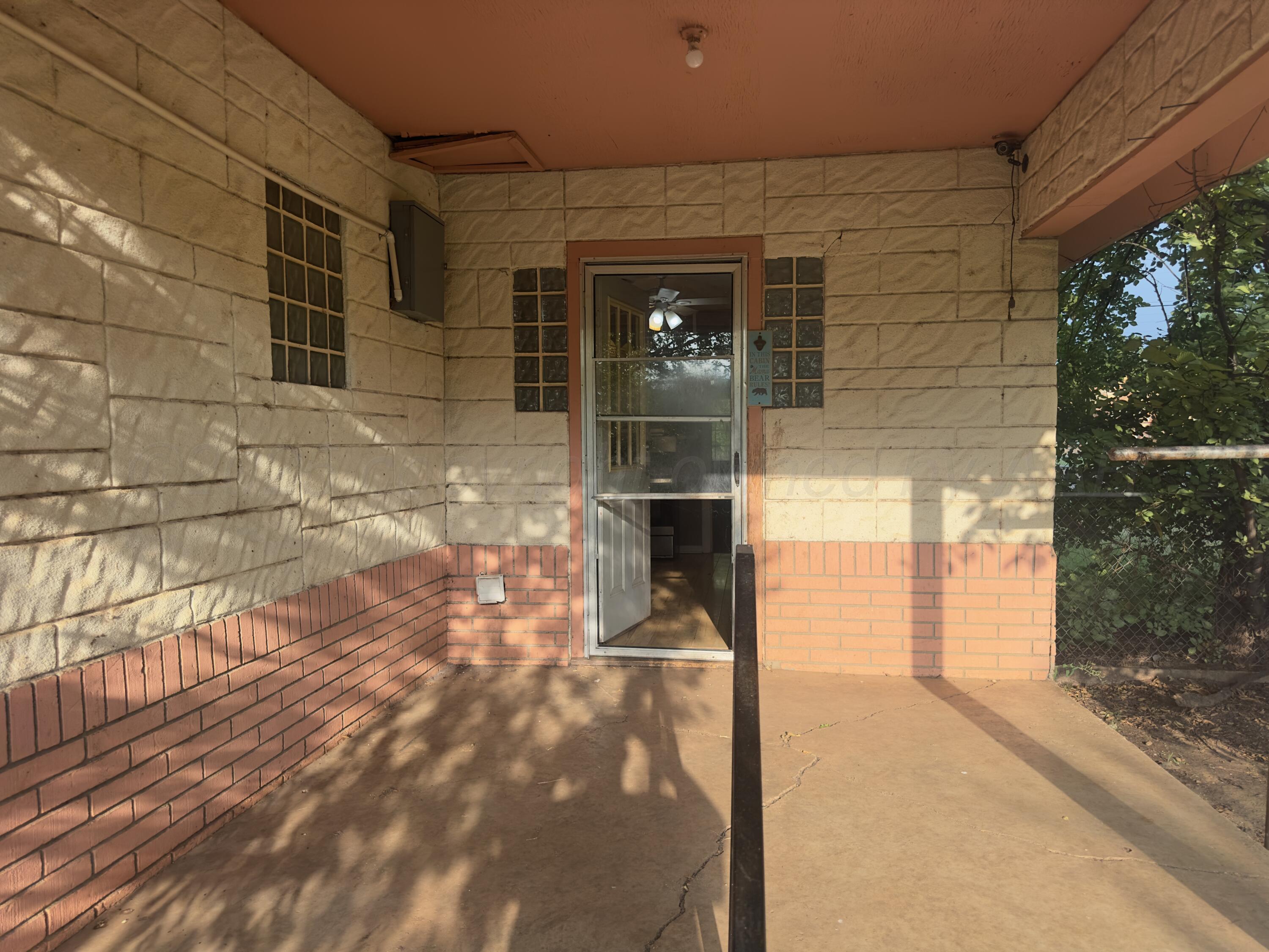 412 North 11th Street Memphis, TX 79245 - Photo 14 of 14 a front view of a house with a glass door