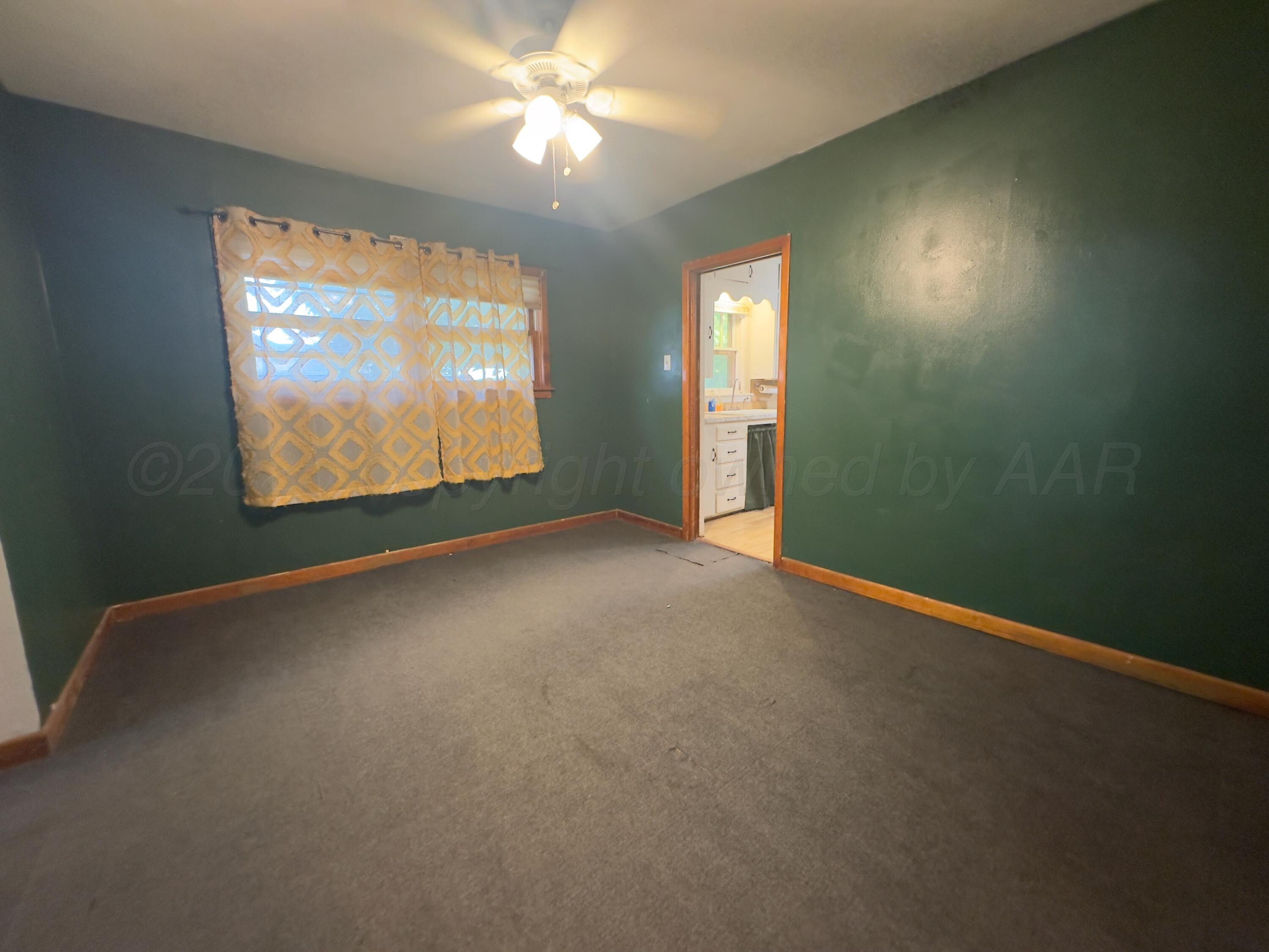 412 North 11th Street Memphis, TX 79245 - Photo 5 of 14 an empty room with windows and fan